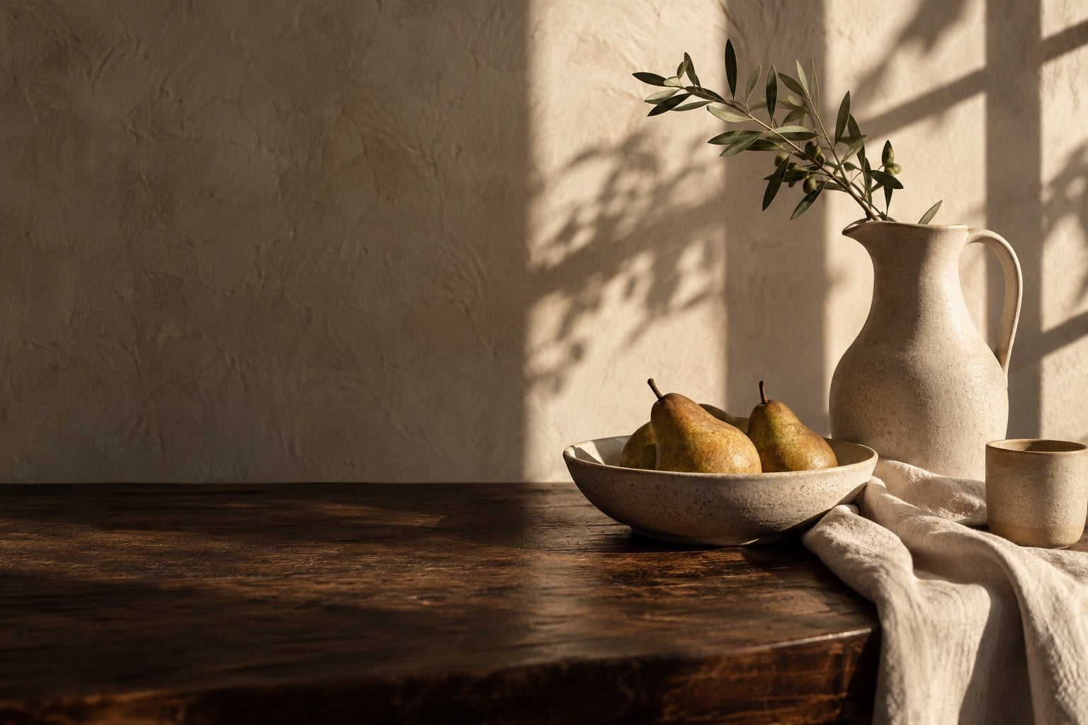 Ceramics, pears and natural linen in warm afternoon light.